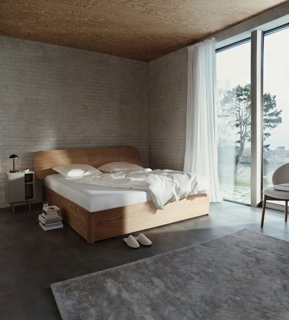 Bedroom with a wooden bed, white bedding and sheer curtains