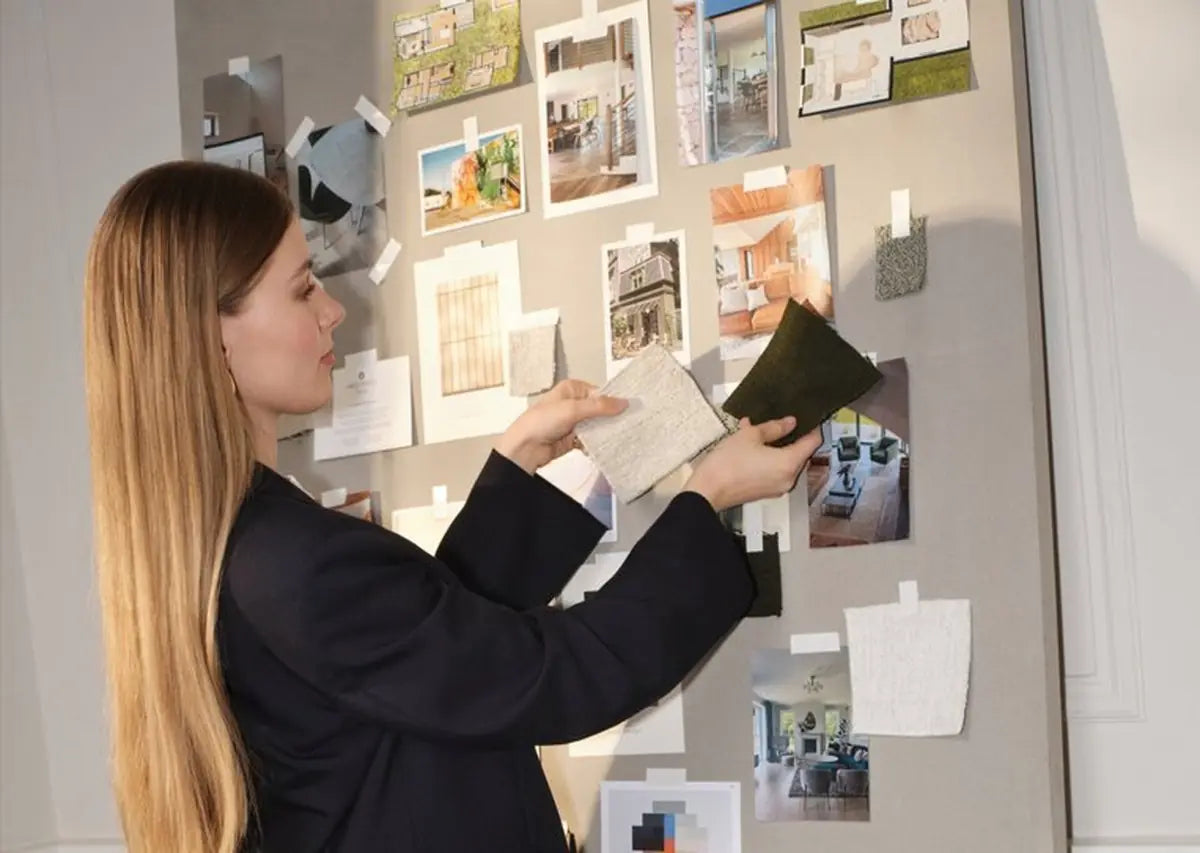 Choosing fabric swatches on a mood board with interior photos