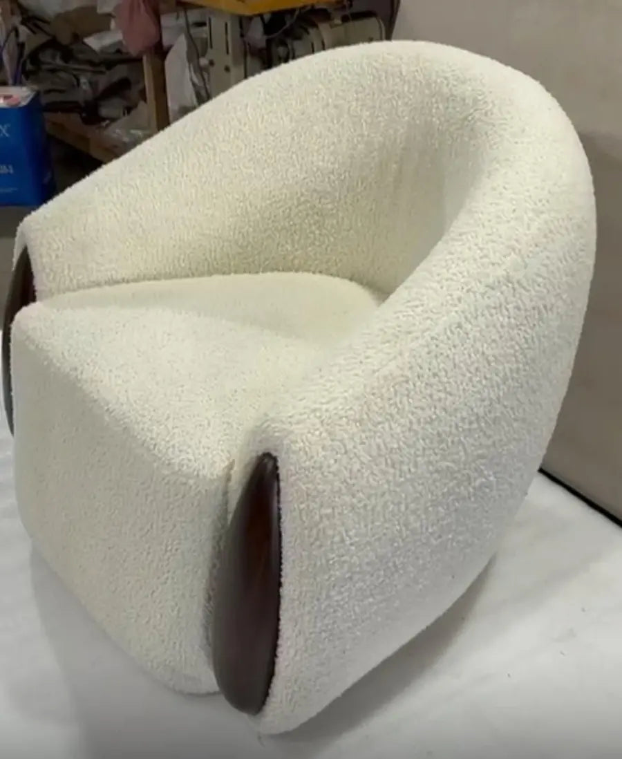 Cream boucle accent chair with a curved back and a walnut accent
