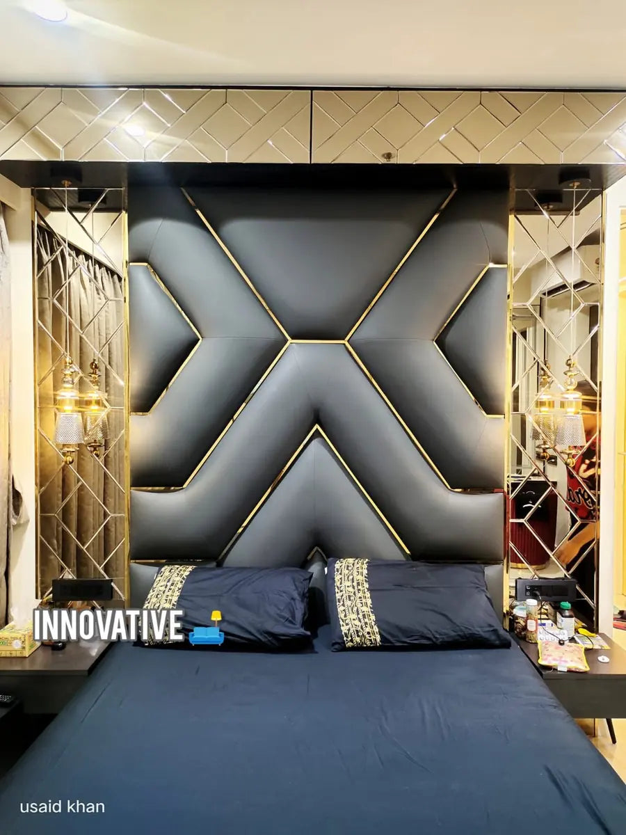 Quilted dark upholstered bed back with a gold X pattern and mirror panels
