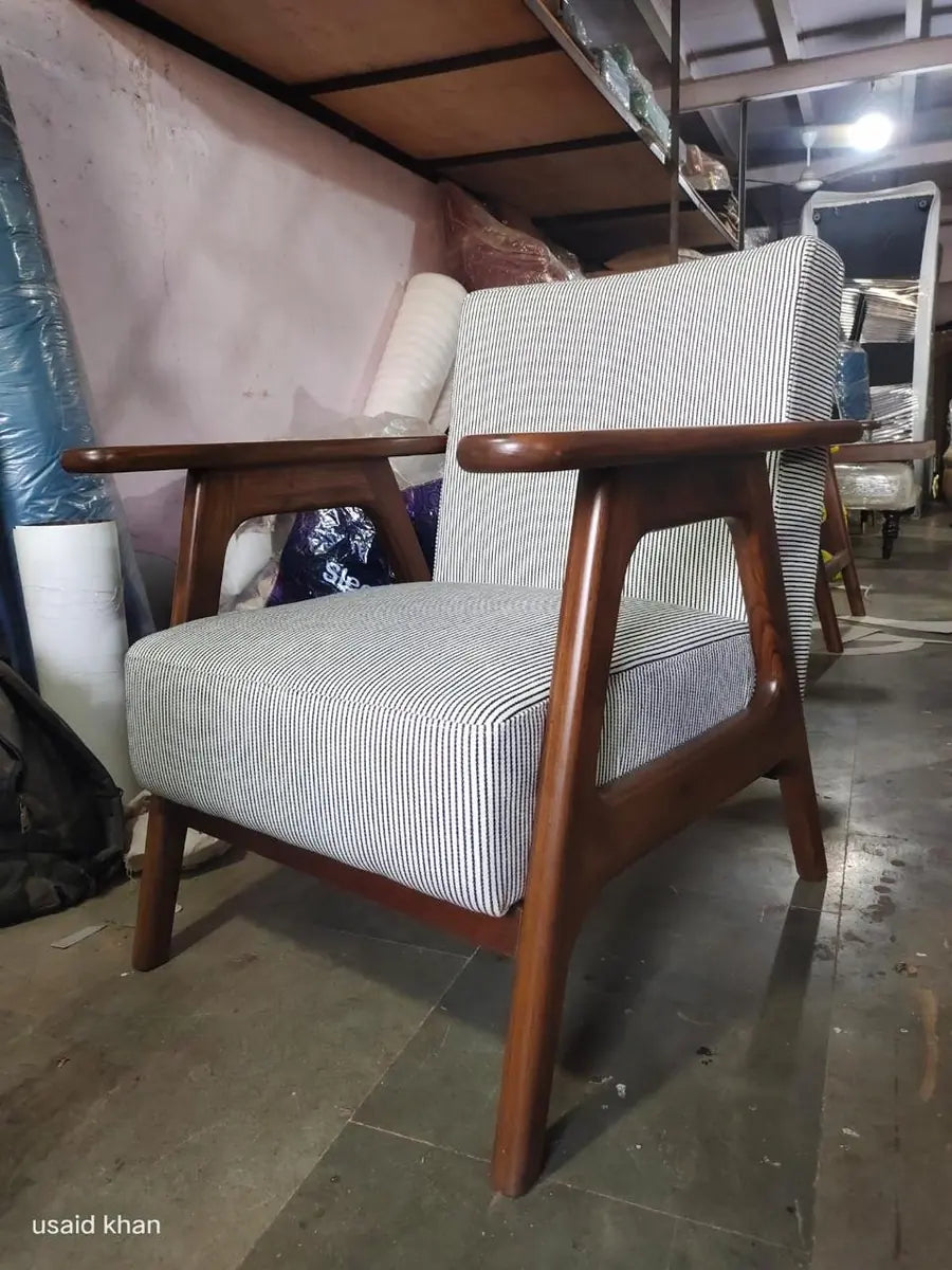 Wooden-framed accent chair with striped upholstery in the workshop