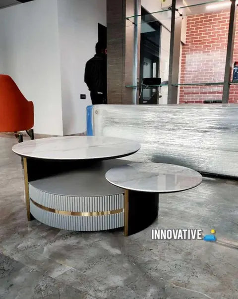 Nesting round centre tables with a white top and gold trim