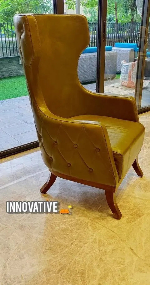 Mustard high-back wing chair beside a window
