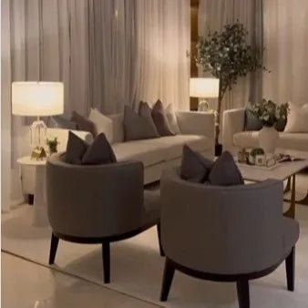 Sitting area with grey armchairs and a console